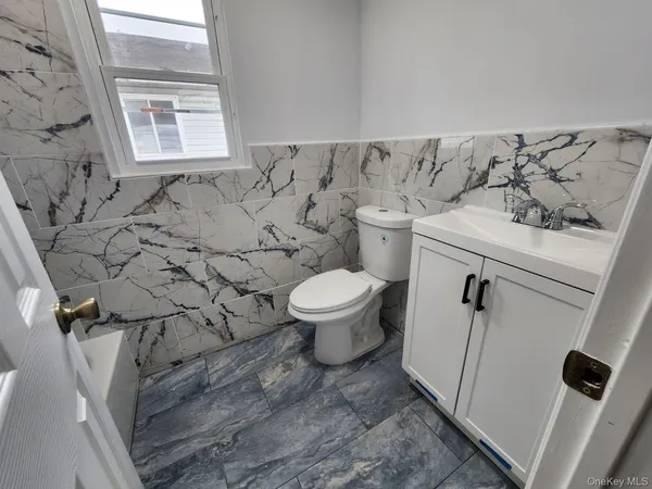 a bathroom with a toilet and a sink