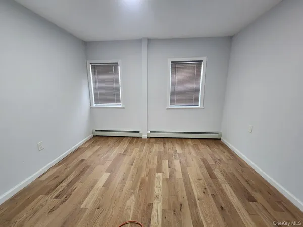 a view of a room with wooden floor and window