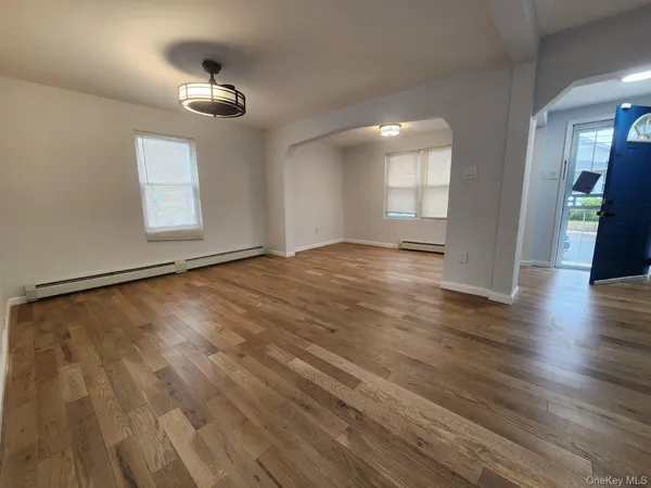 wooden floor in an empty room with a window
