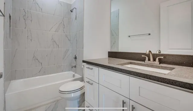 a kitchen with stainless steel appliances a sink a stove and a refrigerator