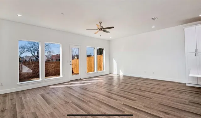 a view of empty room with ceiling fan