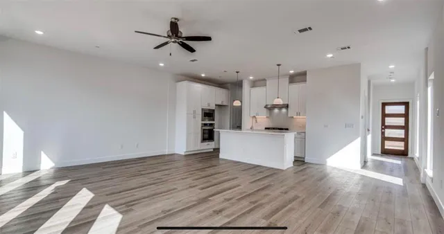 a view of kitchen with cabinets and wooden floor