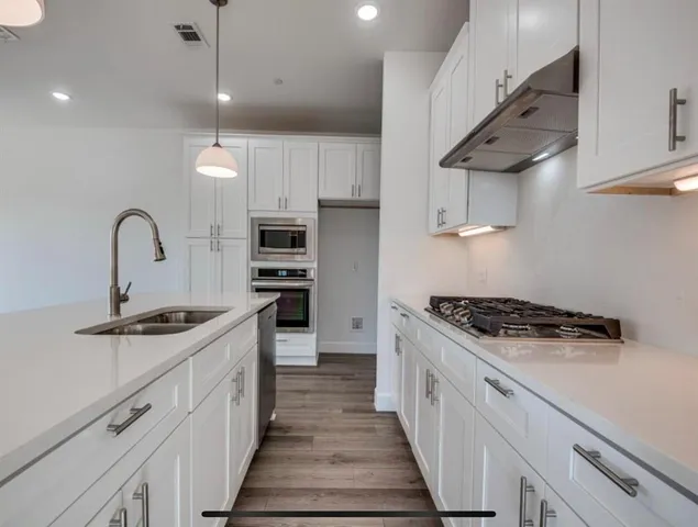 a kitchen with a sink and natural light