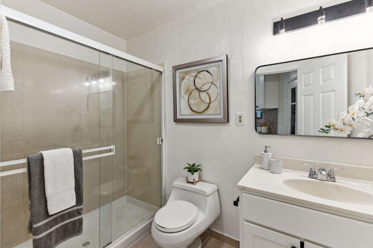 274 West Jackson Street Hayward, CA 94544 - Photo 27 of 29 a bathroom with a toilet a sink and a mirror