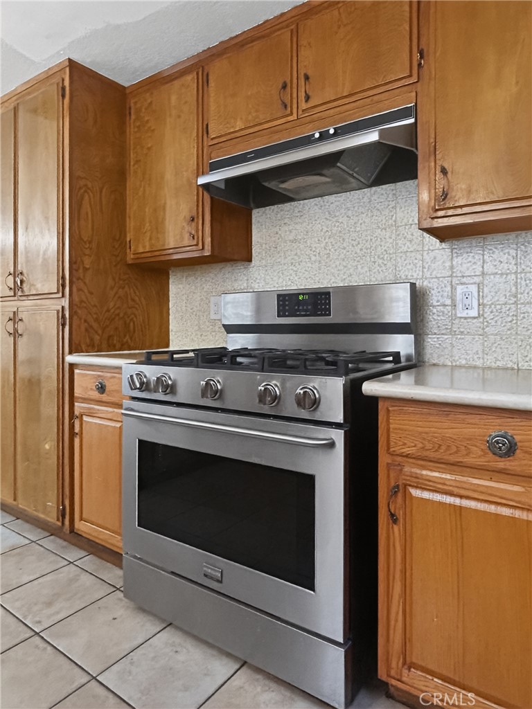 7451 Diamond Street Riverside, CA 92504 - Photo 7 of 31 a stove top oven sitting inside of a kitchen