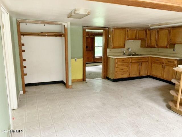 115 Lenox Road Richmond, MA 01254 - Photo 23 of 29 a kitchen with stainless steel appliances a sink and cabinets