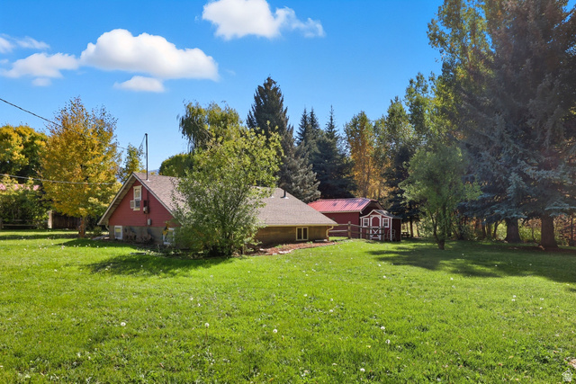 667 North Rapid Creek Road Inkom, ID 83245 - Photo 25 of 29 Expansive green lawn surrounds a red-sided structure with a brown roof