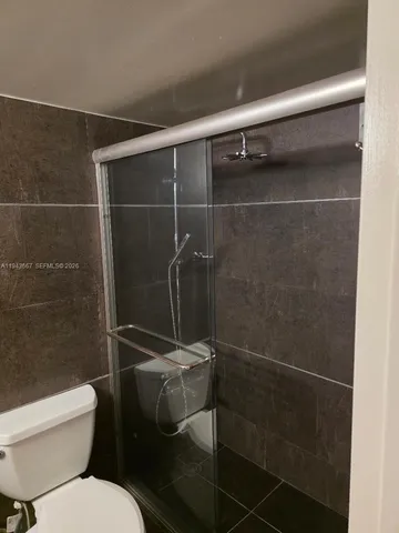 a bathroom with a toilet and a shower