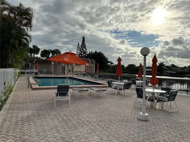 a view of a patio with dining table and chairs with a fire pit
