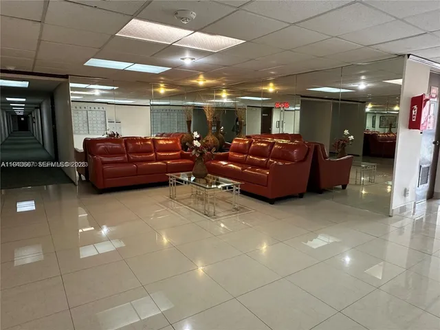 a living room with furniture and a ceiling fan