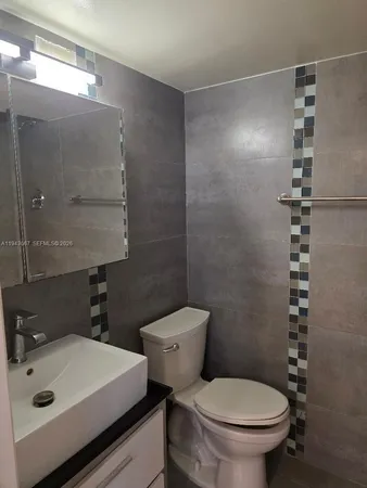 a bathroom with a toilet a sink and shower