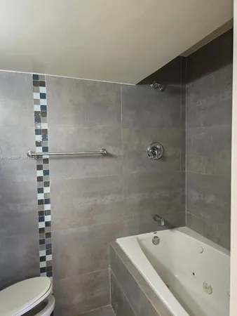 a bathroom with a bathtub and shower