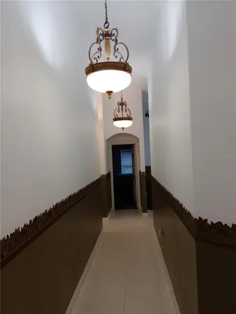 a room with a table and a chandelier