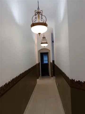 a room with a table and a chandelier