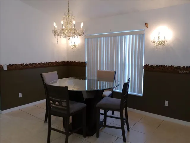 a view of a dining room with furniture and chandelier