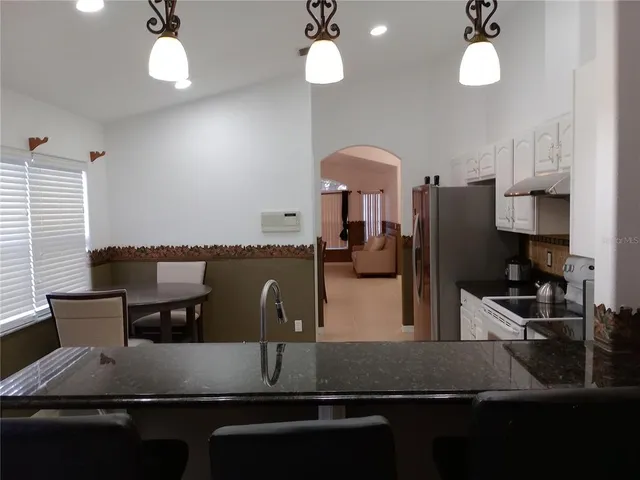a kitchen with counter top space cabinets and stainless steel appliances