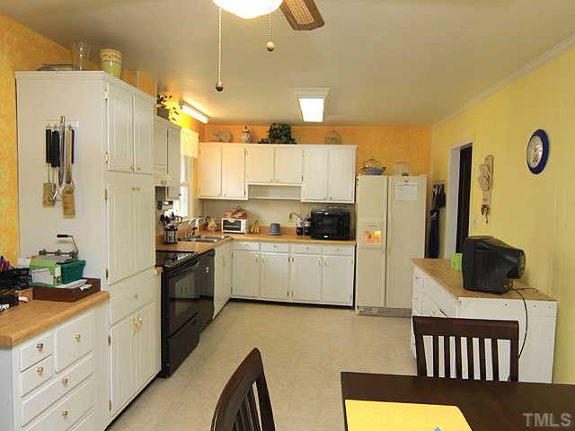 1529 Clermont Road Durham, NC 27713 - Photo 4 of 12 a kitchen with stainless steel appliances a refrigerator sink and cabinets