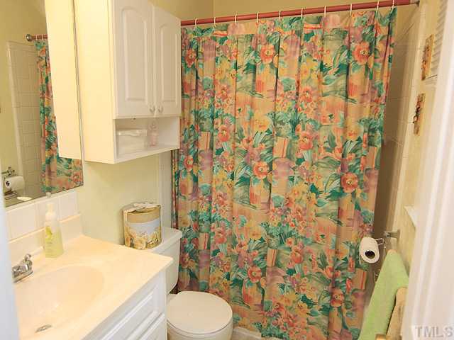 1529 Clermont Road Durham, NC 27713 - Photo 7 of 12 a bathroom with a sink toilet and shower