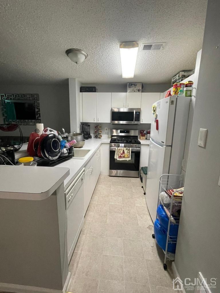 824 Edpas Road New Brunswick, NJ 08901 - Photo 4 of 13 a kitchen that has a sink a refrigerator and a stove