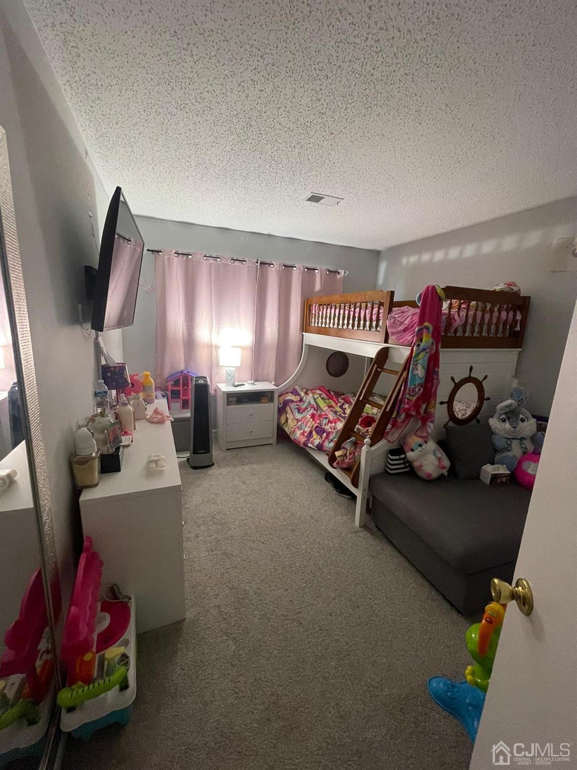 824 Edpas Road New Brunswick, NJ 08901 - Photo 7 of 13 a bedroom with furniture and a flat screen tv