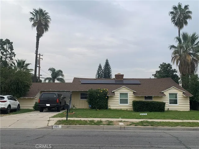 a front view of a house with a garden and yard