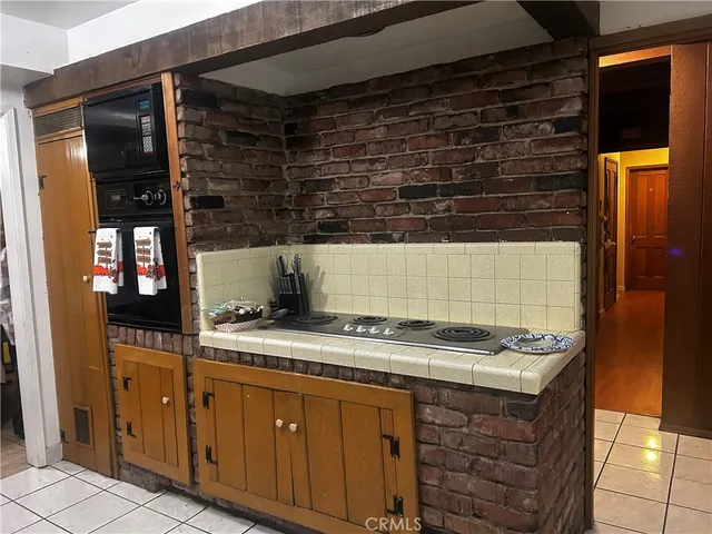 a kitchen with granite countertop a sink and cabinets