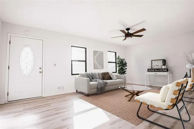 a view of a kitchen with wooden floor and a kitchen space