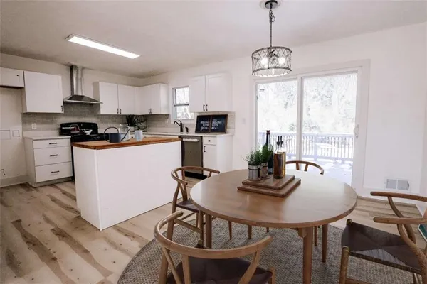 a kitchen with white cabinets and a sink
