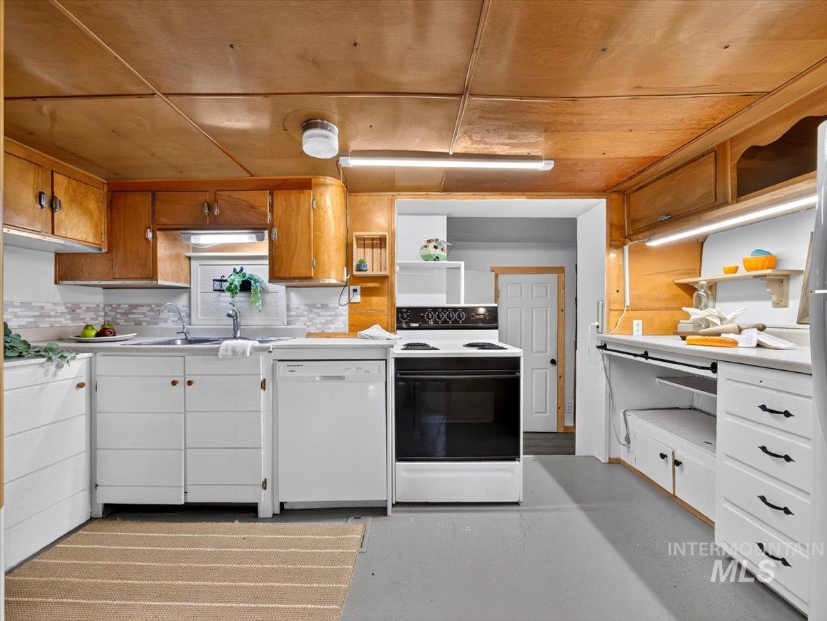 6 Rattlesnake Road Boise City, ID 83716 - Photo 26 of 50 Kitchen featuring wood-finish ceiling, white cabinetry with contrasting hardware, a built-in dishwasher, and an electric range