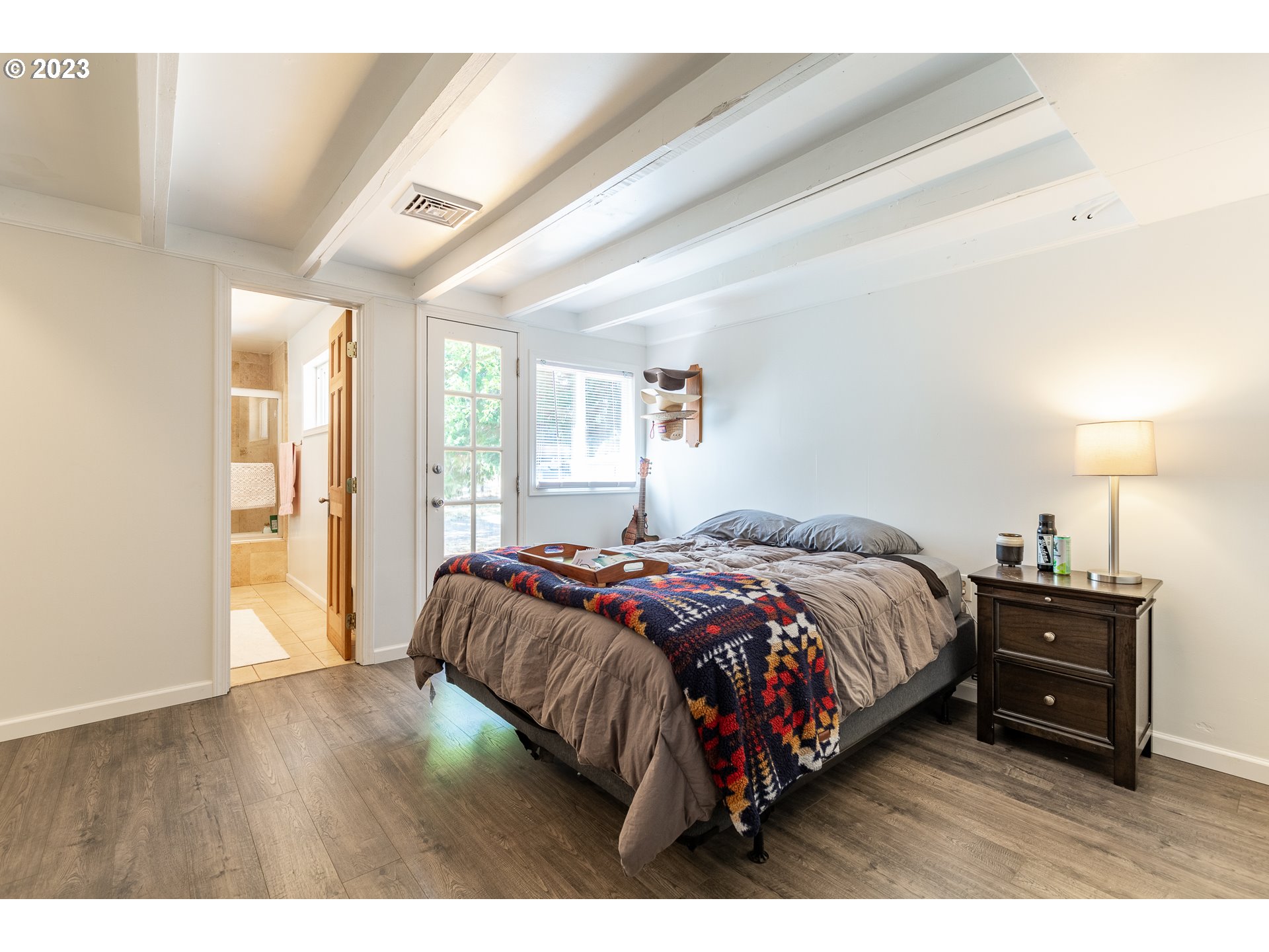 34869 Ede Road Lebanon, OR 97355 - Photo 12 of 42 a bedroom with a bed lamp on desk and a window