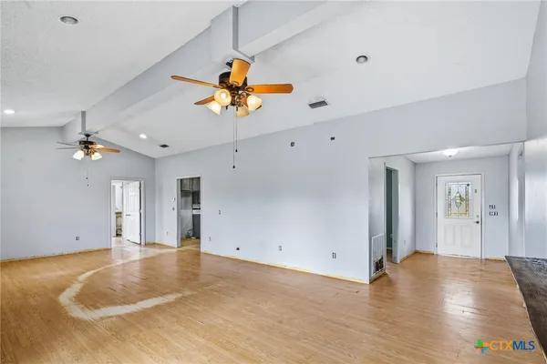 a view of a livingroom with a fireplace furniture and a chandelier fan