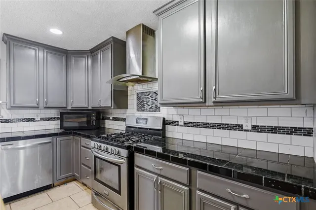 a bathroom with a granite countertop toilet sink and mirror