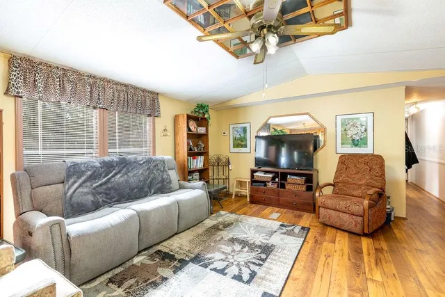 a bathroom with a granite countertop sink a mirror and a shower