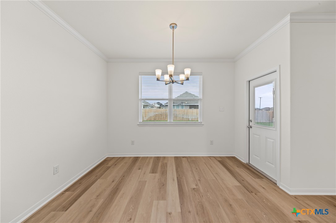 7806 Timber Holw Lane Temple, TX 76502 - Photo 15 of 30 a view of a room with wooden floor chandelier and window