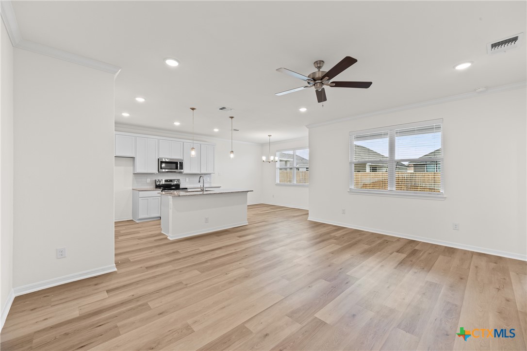 7806 Timber Holw Lane Temple, TX 76502 - Photo 5 of 30 a view of kitchen with kitchen island wooden floors appliances and cabinets