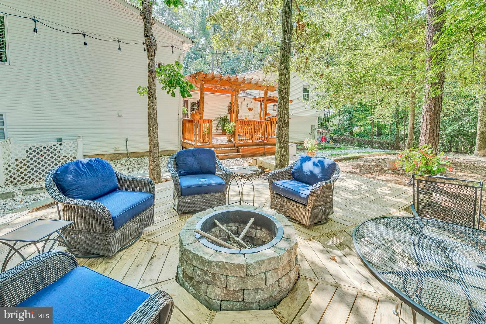 13095 Olivet Road Lusby, MD 20657 - Photo 4 of 48 Custom deck with fire pit! Lots of natural shade