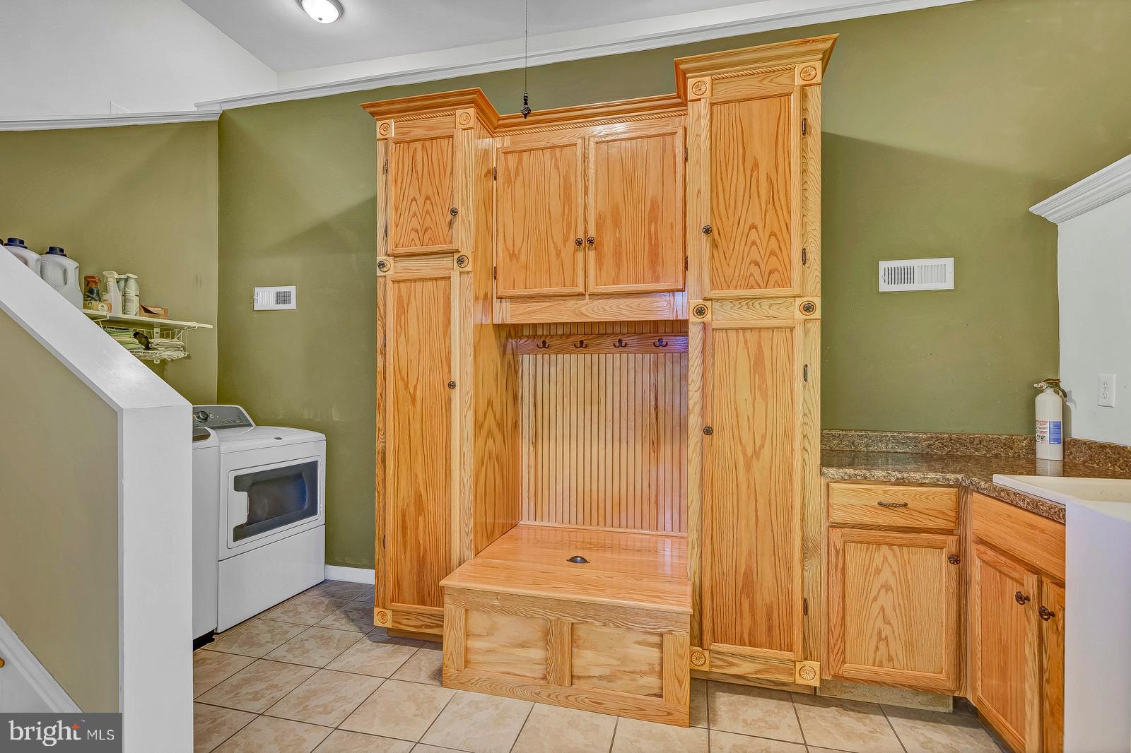 13095 Olivet Road Lusby, MD 20657 - Photo 42 of 48 laundry w/ custom built cabinetry