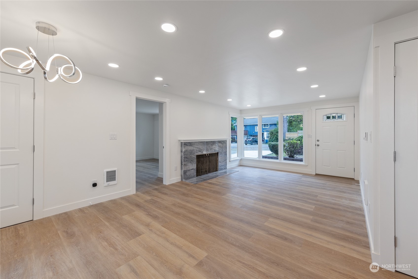 7614 South 113th Street Seattle, WA 98178 - Photo 15 of 24 an empty room with wooden floor and fireplace