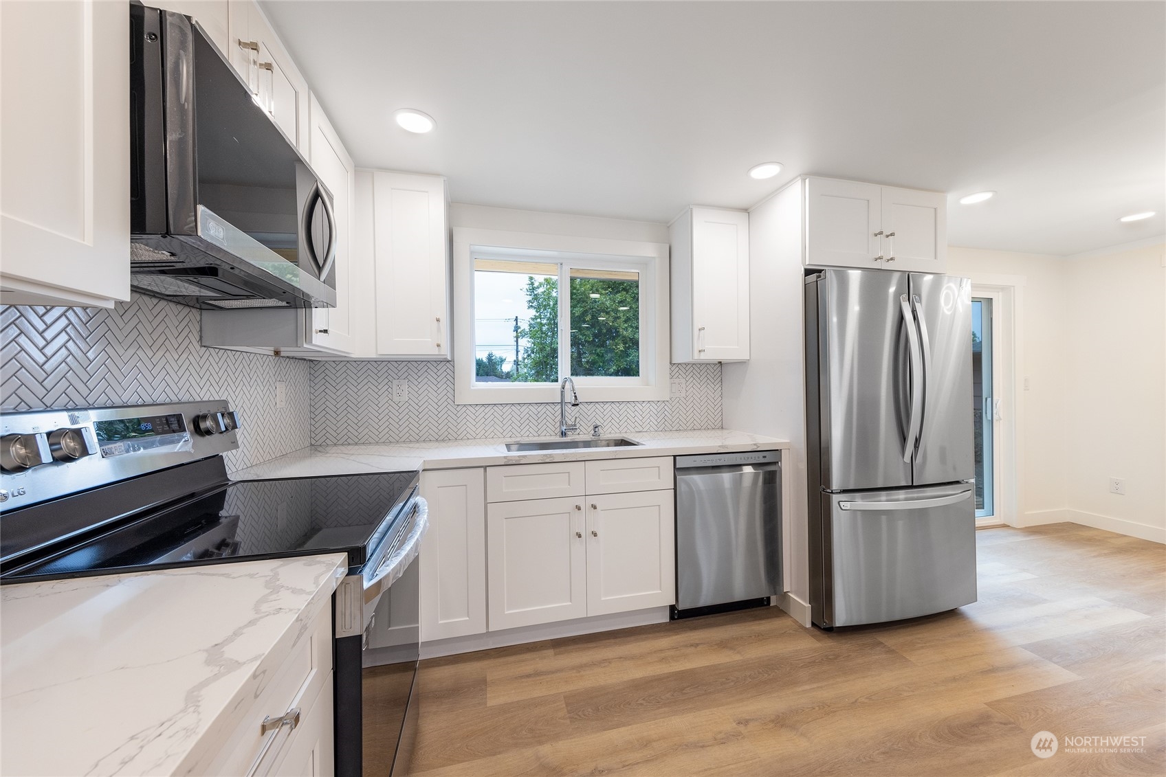 7614 South 113th Street Seattle, WA 98178 - Photo 16 of 24 a kitchen with stainless steel appliances a refrigerator sink and microwave
