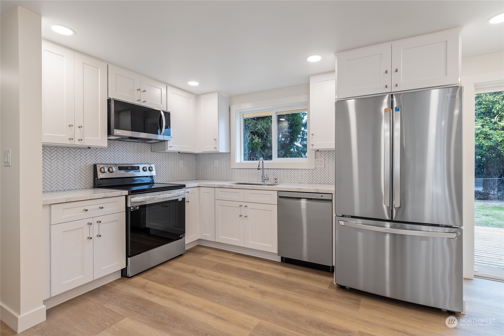 7614 South 113th Street Seattle, WA 98178 - Photo 18 of 24 a kitchen with a refrigerator stove and microwave