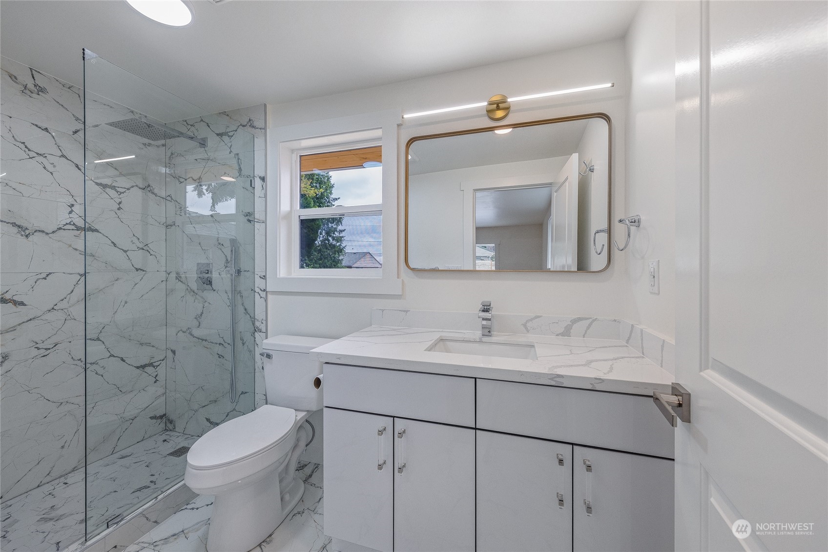 7614 South 113th Street Seattle, WA 98178 - Photo 21 of 24 a bathroom with a toilet sink and mirror