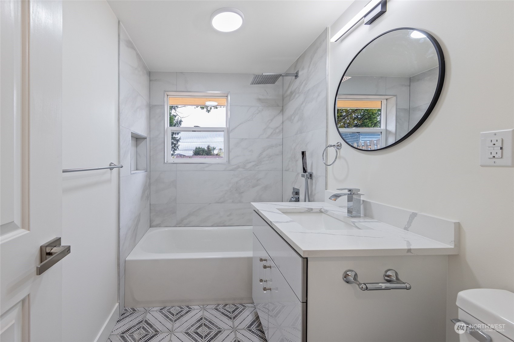 7614 South 113th Street Seattle, WA 98178 - Photo 22 of 24 a bathroom with a sink mirror and bathtub