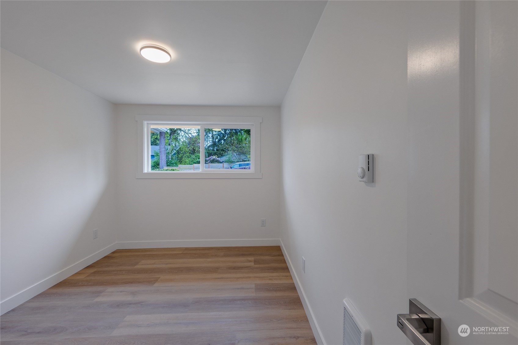 7614 South 113th Street Seattle, WA 98178 - Photo 23 of 24 a view of empty room with wooden floor
