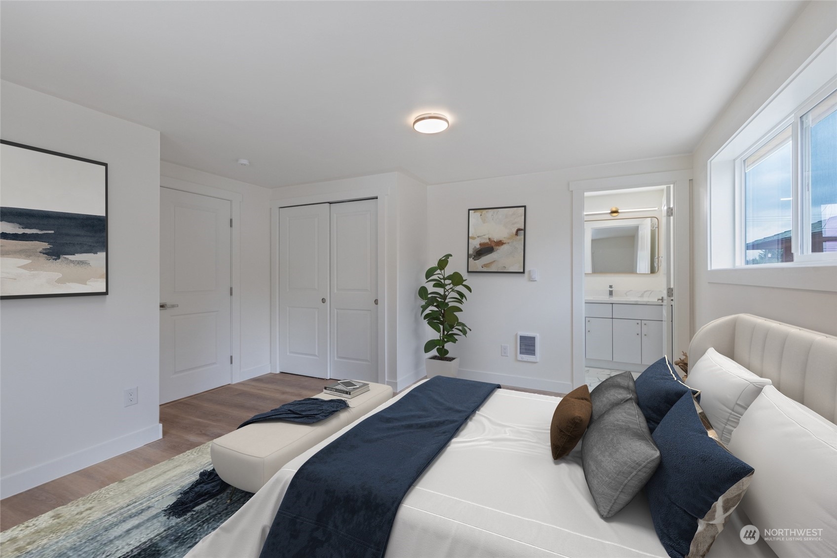 7614 South 113th Street Seattle, WA 98178 - Photo 7 of 24 a bedroom with a large bed and a potted plant