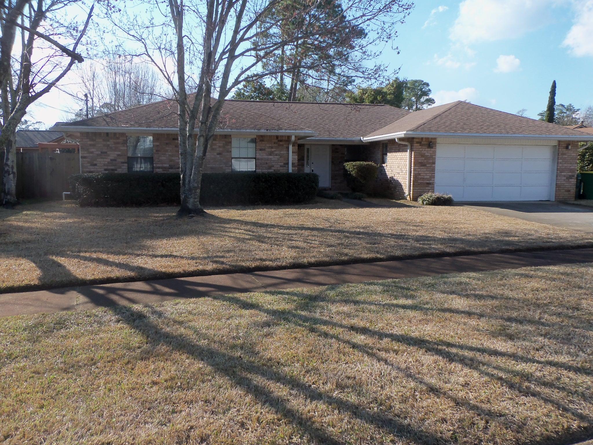 245 Elliott Road Mary Esther, FL 32569 - Photo 1 of 13 a front view of a house with a yard and garage