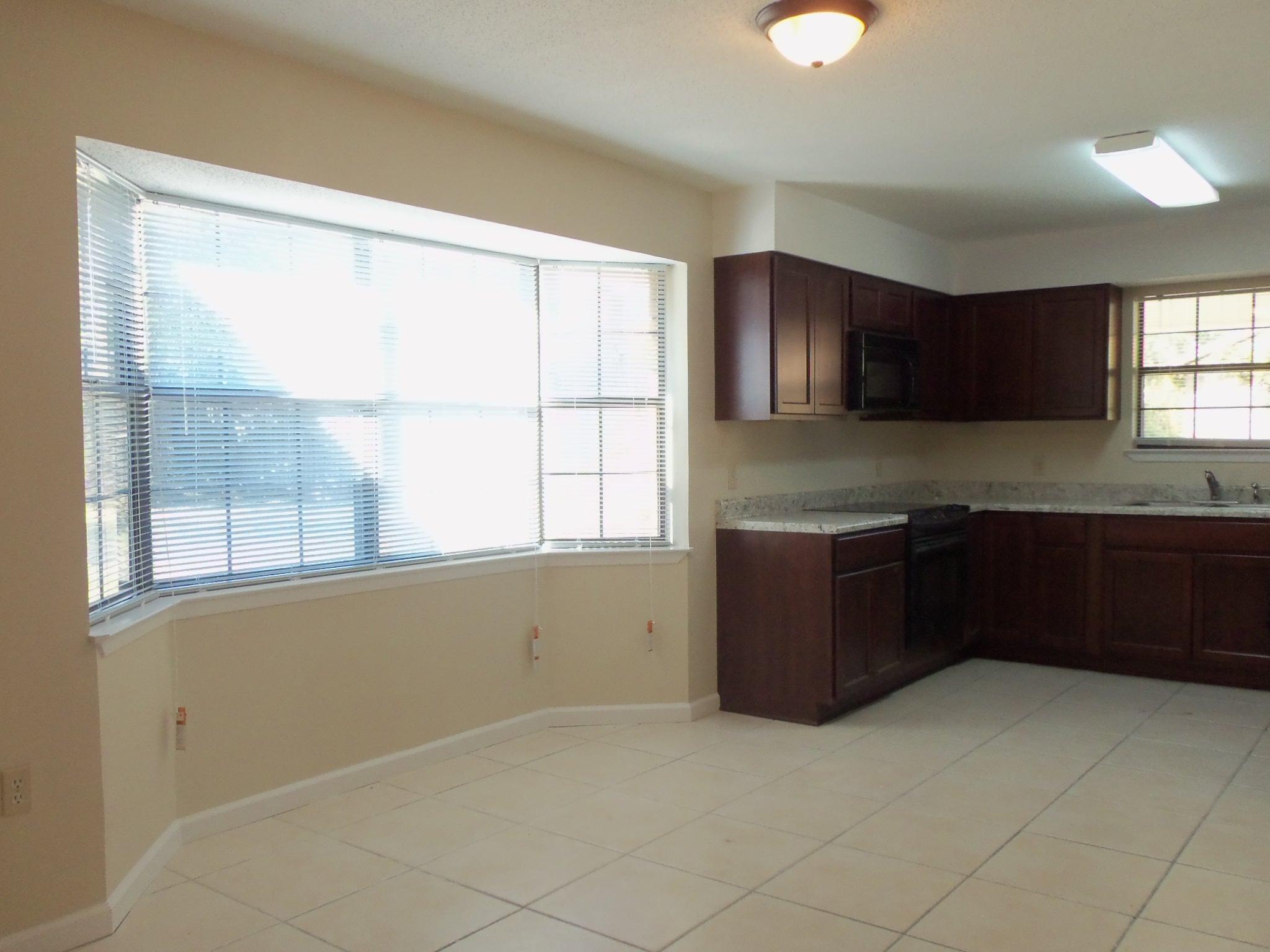 245 Elliott Road Mary Esther, FL 32569 - Photo 3 of 13 a kitchen with a cabinets and window