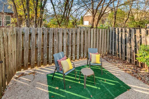 a backyard of a house with table and chairs