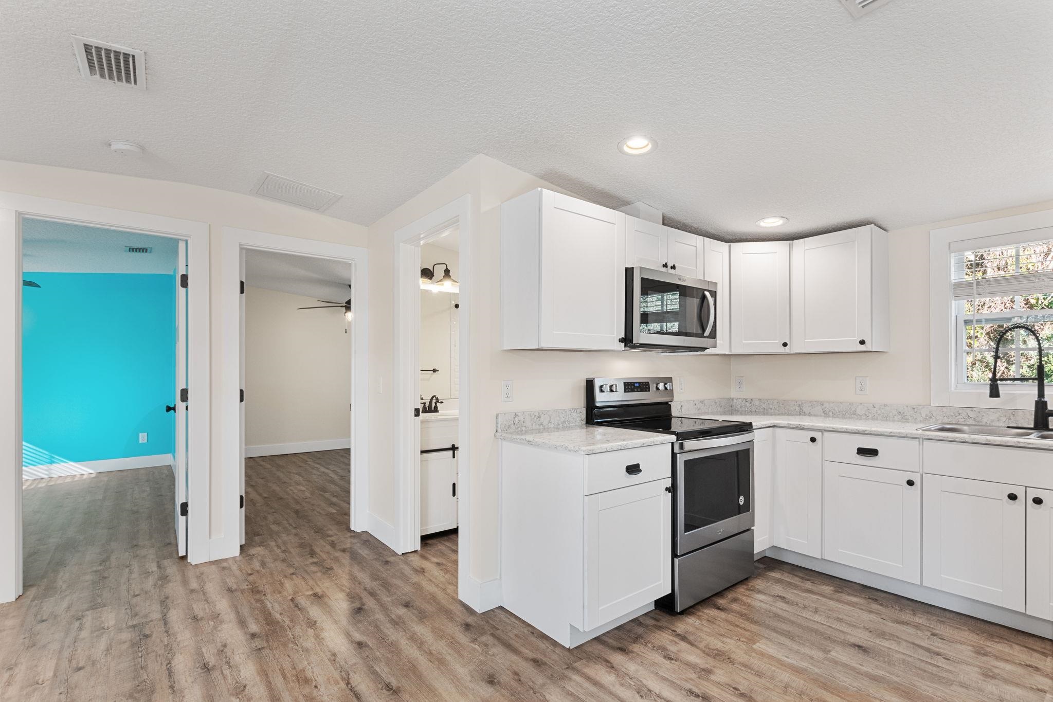 1385 Highland Boulevard St. Augustine, FL 32084 - Photo 13 of 47 a kitchen with stainless steel appliances granite countertop a stove and a refrigerator