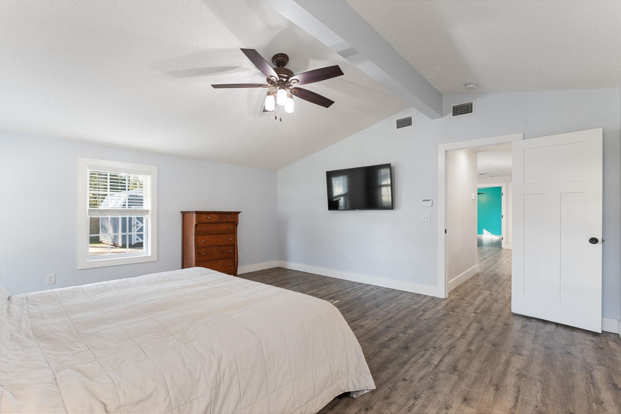 1385 Highland Boulevard St. Augustine, FL 32084 - Photo 19 of 47 a bedroom with a large bed and a flat screen tv