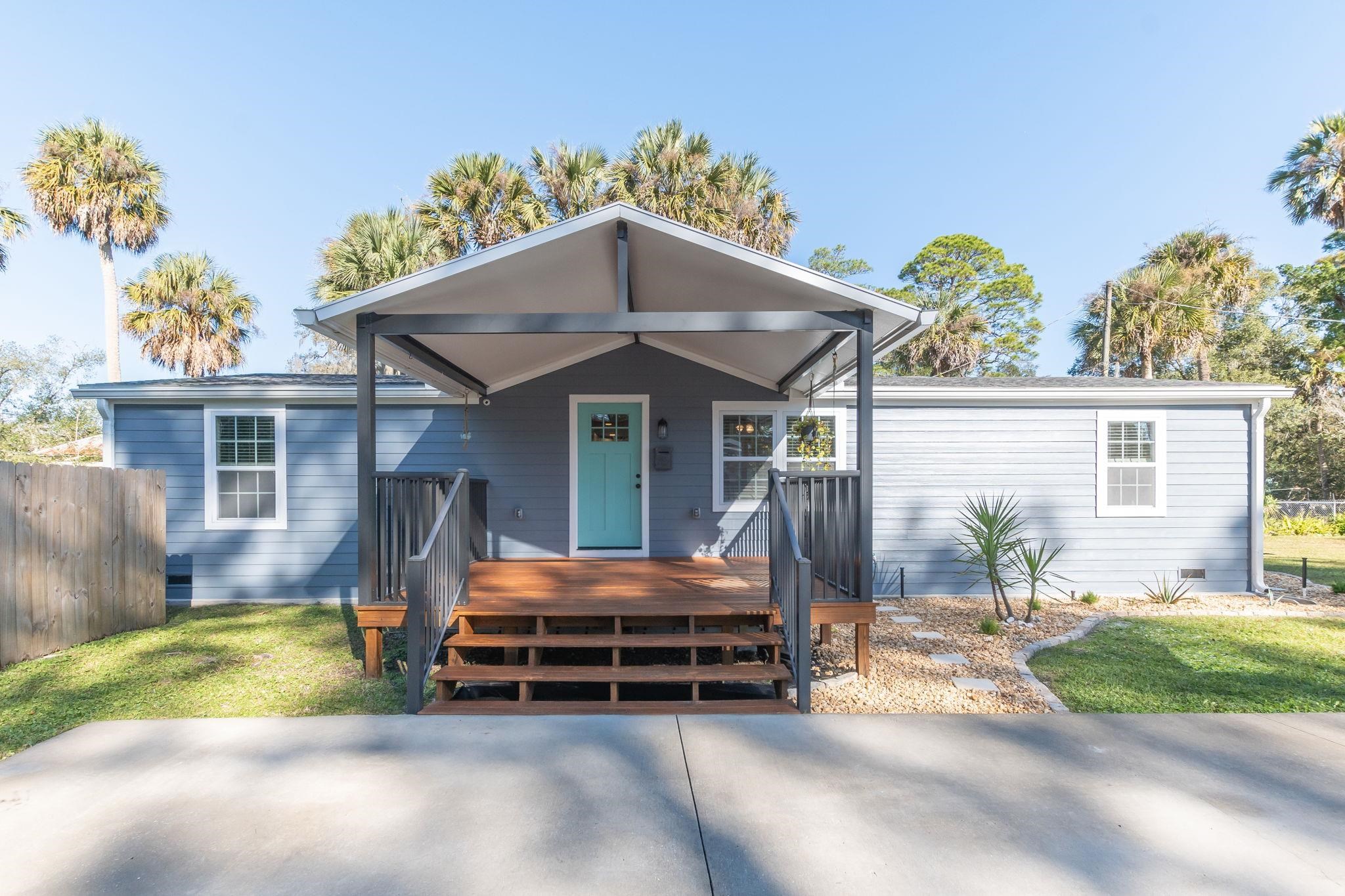 1385 Highland Boulevard St. Augustine, FL 32084 - Photo 2 of 47 a backyard of a house with yard and outdoor seating